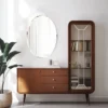 Minimalist frameless oval mirror installed in bathroom interior